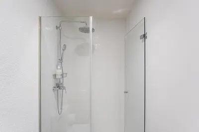 a shower with a glass door in a bathroom at GuestReady - A lovely retreat in Porto in Porto
