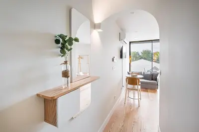 a hallway with a mirror and a table in a house at GuestReady - A lovely retreat in Porto in Porto