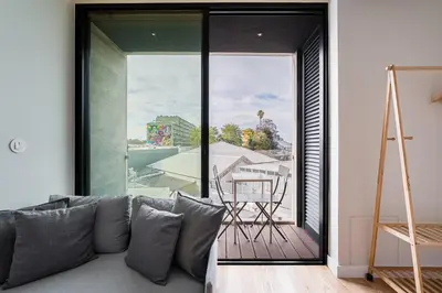 a living room with a couch and a large window at GuestReady - A lovely retreat in Porto in Porto