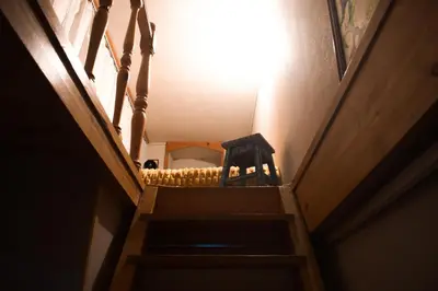 a stairway with a wooden chair in a room at A Oficina do Costa in Vila Nova de Gaia
