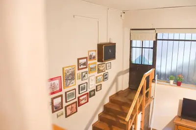a hallway with a staircase with pictures on the wall at A Oficina do Costa in Vila Nova de Gaia