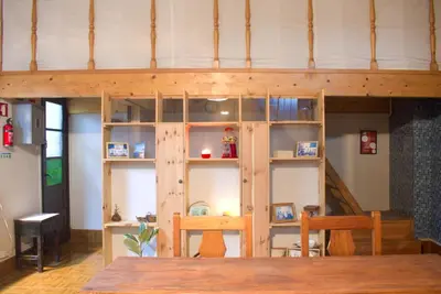a loft bed in a room with a table at A Oficina do Costa in Vila Nova de Gaia