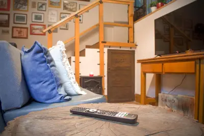 a remote control sitting on top of a couch at A Oficina do Costa in Vila Nova de Gaia