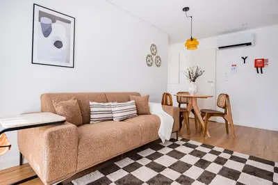 a living room with a couch and a table at Povoa Terrace, A Curated Escape with Large Balcony in Porto