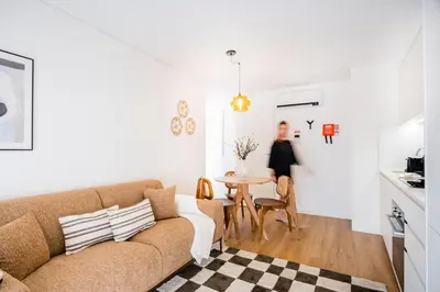 a living room with a couch and a table at Povoa Terrace, A Curated Escape with Large Balcony in Porto