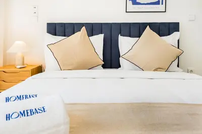a bedroom with a large white bed with pillows at Povoa Terrace, A Curated Escape with Large Balcony in Porto