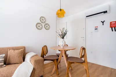 a living room with a couch and a table at Povoa Terrace, A Curated Escape with Large Balcony in Porto