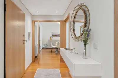 a living room with a white counter and a mirror at GuestReady - Modern apartment in Boavista in Porto
