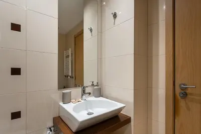 a bathroom with a white sink and a mirror at GuestReady - Modern apartment in Boavista in Porto