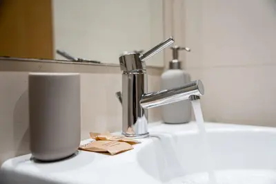 a bathroom sink with a faucet and a toothbrush at GuestReady - Modern apartment in Boavista in Porto