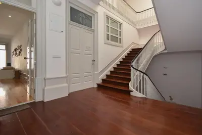 a hallway with a staircase and a white wall at Art & City in Porto