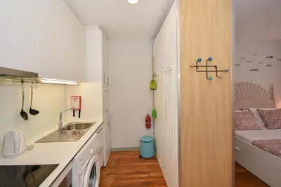 a small kitchen with a sink and a bed at Art & City in Porto