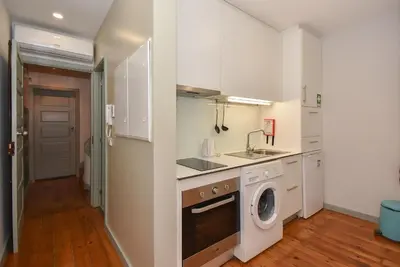 a kitchen with a sink and a washing machine at Art & City in Porto
