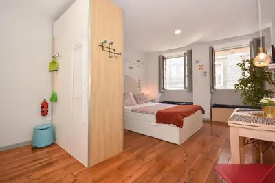 a bedroom with a bed and a wooden floor at Art & City in Porto
