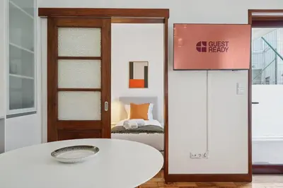 a room with a door and a table and a bed at GuestReady - Porto stay with outdoor charm in Porto