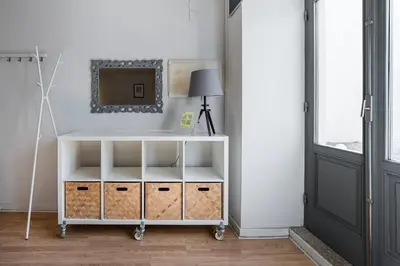 a room with a white shelf with a lamp and a mirror at GuestReady - Relaxing getaway in Santos Pousada in Porto