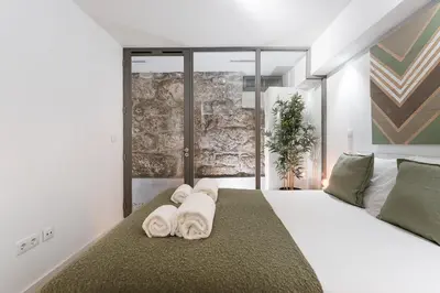 a bedroom with a white bed with towels on it at GuestReady - Relaxing getaway in Santos Pousada in Porto