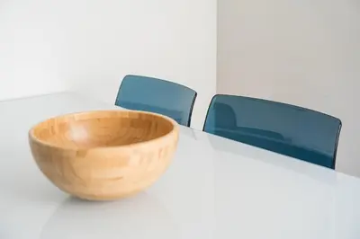 a wooden bowl on a white table with two blue chairs at GuestReady - Relaxing getaway in Santos Pousada in Porto