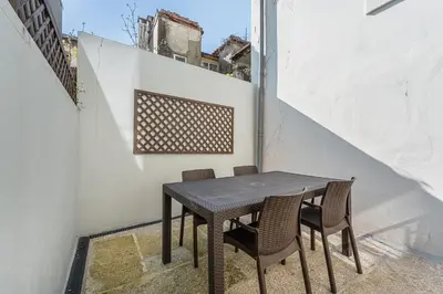 a black table and chairs on a balcony at GuestReady - Relaxing getaway in Santos Pousada in Porto