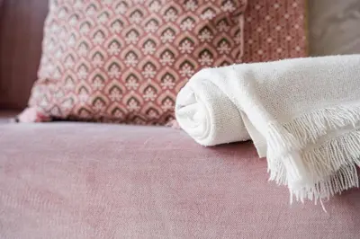 a white towel sitting on a pink bed with a pillow at GuestReady - Urban paradise in Porto in Porto