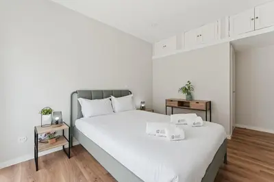 a bedroom with a large white bed with two night stands at GuestReady - Lovely family home in Boavista in Porto