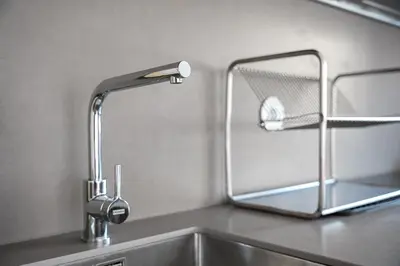 a kitchen sink with a faucet and a mirror at GuestReady - Lovely family home in Boavista in Porto
