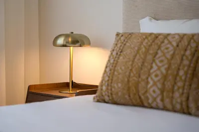a close up of a bed with a lamp on a table at GuestReady - Blissful escape in Porto in Porto
