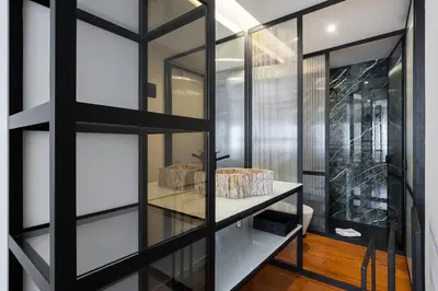 a bathroom with a glass wall with a sink in it at GuestReady - Blissful escape in Porto in Porto