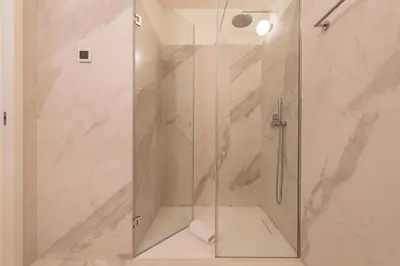 a shower with a glass door in a bathroom at Almada 559 - Almeida Garrett Nook by Lisbeyond in Porto