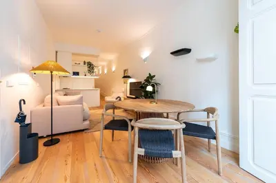 a kitchen and living room with a counter and a table at Almada 559 - Almeida Garrett Nook by Lisbeyond in Porto