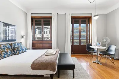 a bedroom with a bed and a table and chairs at GuestReady - Rivoli Studio in Porto