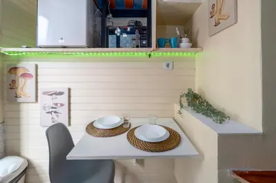 a small table in a tiny bathroom with a toilet at Microloft in the heart of Porto in Porto
