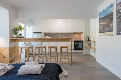 a kitchen and dining room with a table and chairs at GuestReady - Sunny patio paradise in Porto in Porto