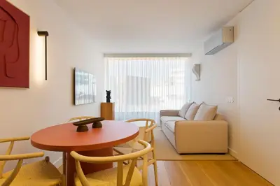a living room with a table and a couch at Porto - Boavista Casa Da Música- Art Gallery Apartment III in Porto
