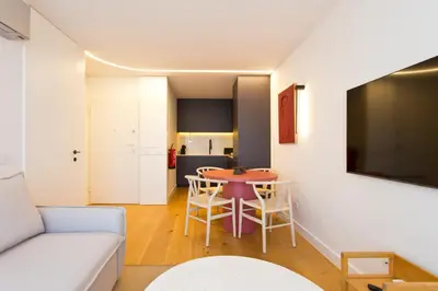 a living room with a table and a couch at Porto - Boavista Casa Da Música- Art Gallery Apartment III in Porto