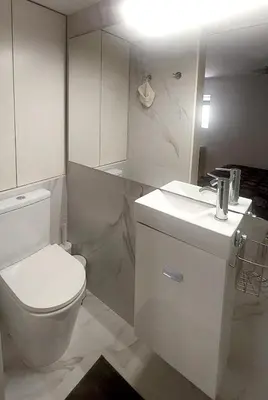 a white bathroom with a toilet and a sink at Casa dos Moinhos - Country House in Porto City in Porto