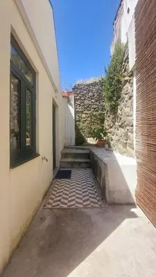 a stairway leading to a building with a stone wall at Casa dos Moinhos - Country House in Porto City in Porto