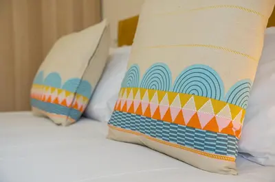 two pillows sitting on top of a bed at GuestReady - Marble Root in Porto