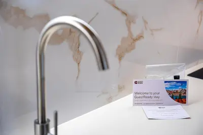 a bathroom counter with a sink and a sign on it at GuestReady - Marble Root in Porto