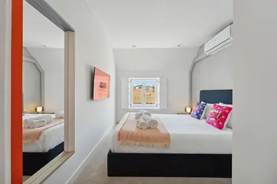 a bedroom with two beds and a mirror at GuestReady - Cheerful place in Porto in Porto