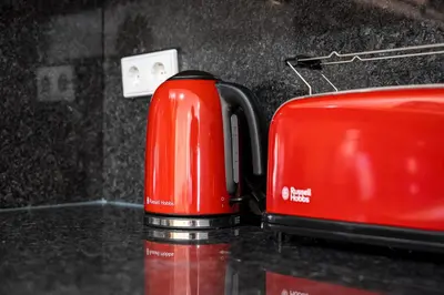 a red toaster sitting on top of a counter at GuestReady - Cheerful place in Porto in Porto