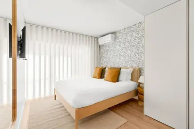 a living room with a couch and a dining room at Urban Comfort @ Bonfim Boutique Flats in Porto