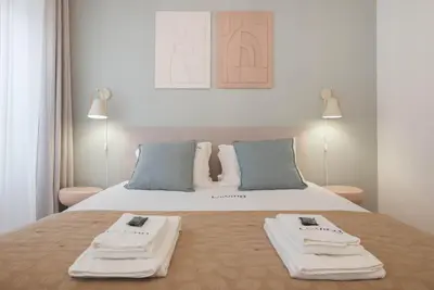 a bedroom with a bed with two towels on it at Liiiving in Porto - Downtown Comfort House in Porto