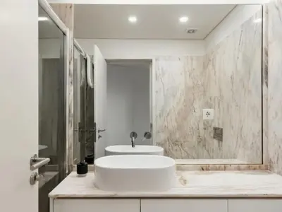 a white bathroom with a sink and a shower at Stylish Flat with Balcony, In Central Porto in Porto