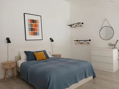 a bedroom with a blue bed and a mirror at Oporto 123 Covelo in Porto