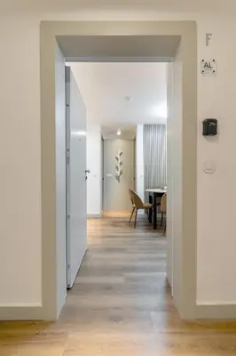an open hallway with white walls and wood floors at Modern 1BR Apartment - Brand New Bonjardim F in Porto