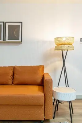 a living room with a couch and a lamp at Modern 1BR Apartment - Brand New Bonjardim F in Porto