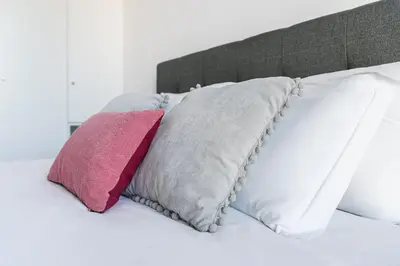 two pillows sitting on top of a bed at GuestReady - One Step Closer in Porto