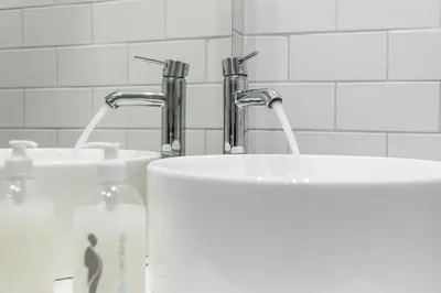 two sinks in a bathroom with two faucets at GuestReady - One Step Closer in Porto
