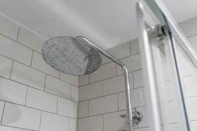 a shower with a shower head in a bathroom at GuestReady - One Step Closer in Porto